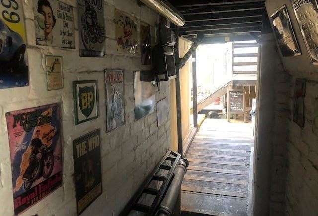 This narrow passageway leads from the back of the pub to the outside area and is lined with many old metal signs