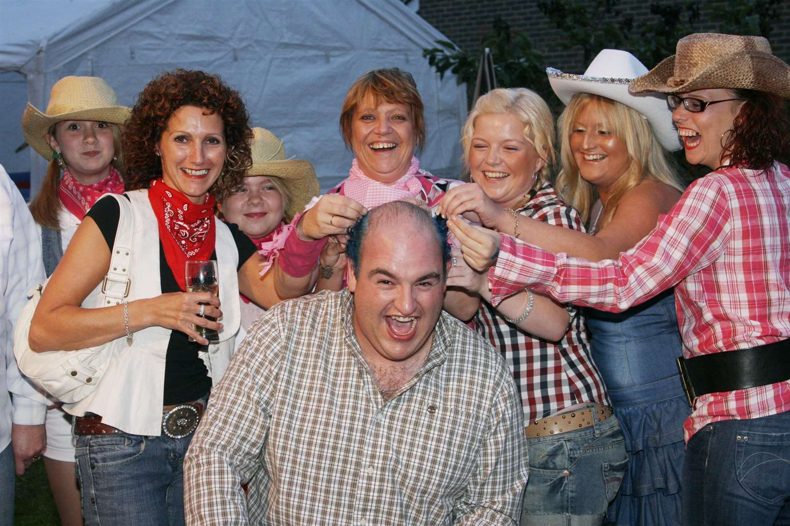 Punters and the landlady of the Buffalo Head pub in Chart Sutton, near Maidstone, cuts Anthony Creasey hair with clippers for charity in August 2008. The pub closed in 2011. Picture: John Westhrop