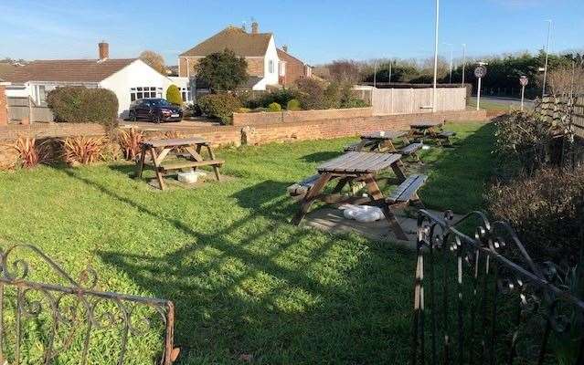 This triangular-shaped grassed garden area sits at the side of pub