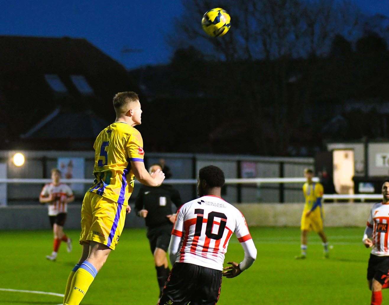 Sittingbourne defender Joe Tyrie heads clear ahead of Sheppey United striker Javaun Splatt. Picture: Marc Richards