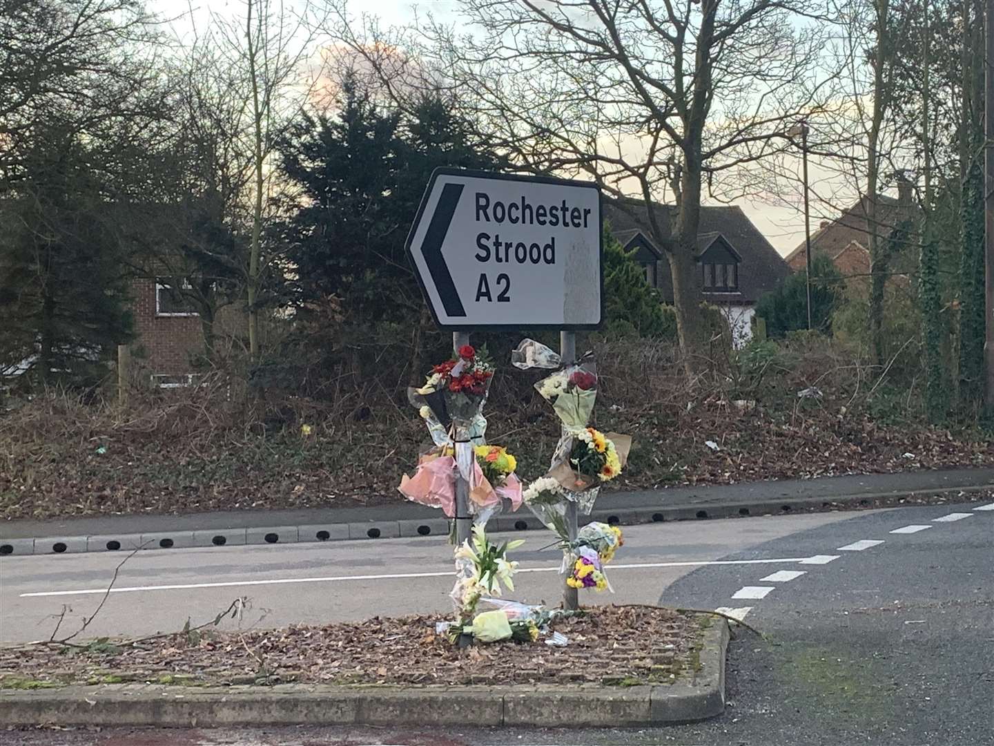 Flowers were attached to a sign by the Three Crutches roundabout