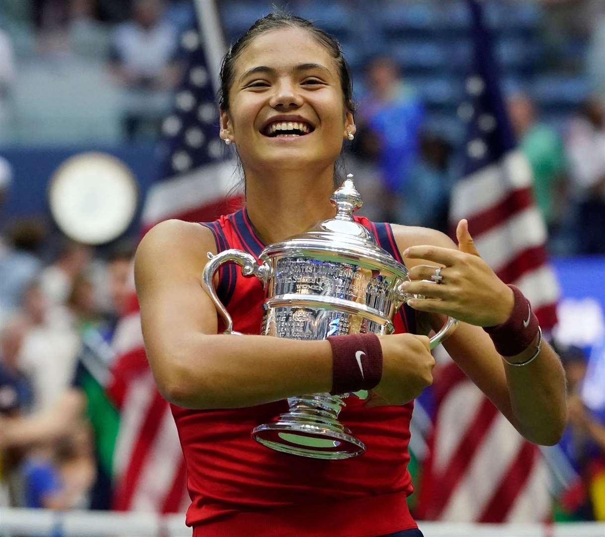 Emma Raducanu hugs the US Open championship trophy after her sensational victory over Leylah Fernandez. Picture: Elise Amendola/AP/PA Wire