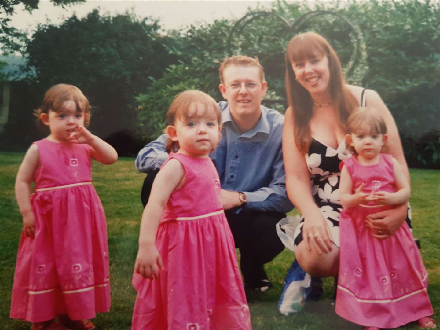 The triplets from Gravesend pictured with their parents when they were just toddlers