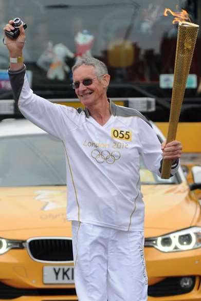 Ex-butcher Graham Cooper carries the Olympic torch through Seabrook