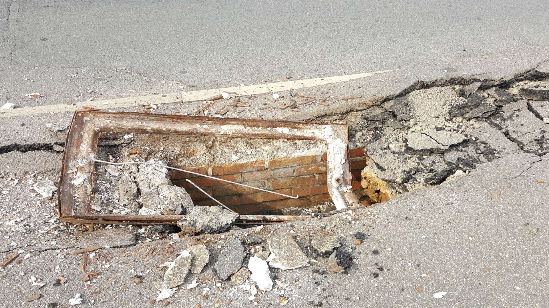 A manhole cover has been ripped from the ground.