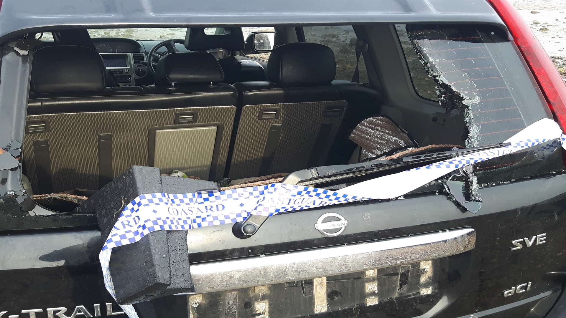 The smashed window of the Nissan X-Trail