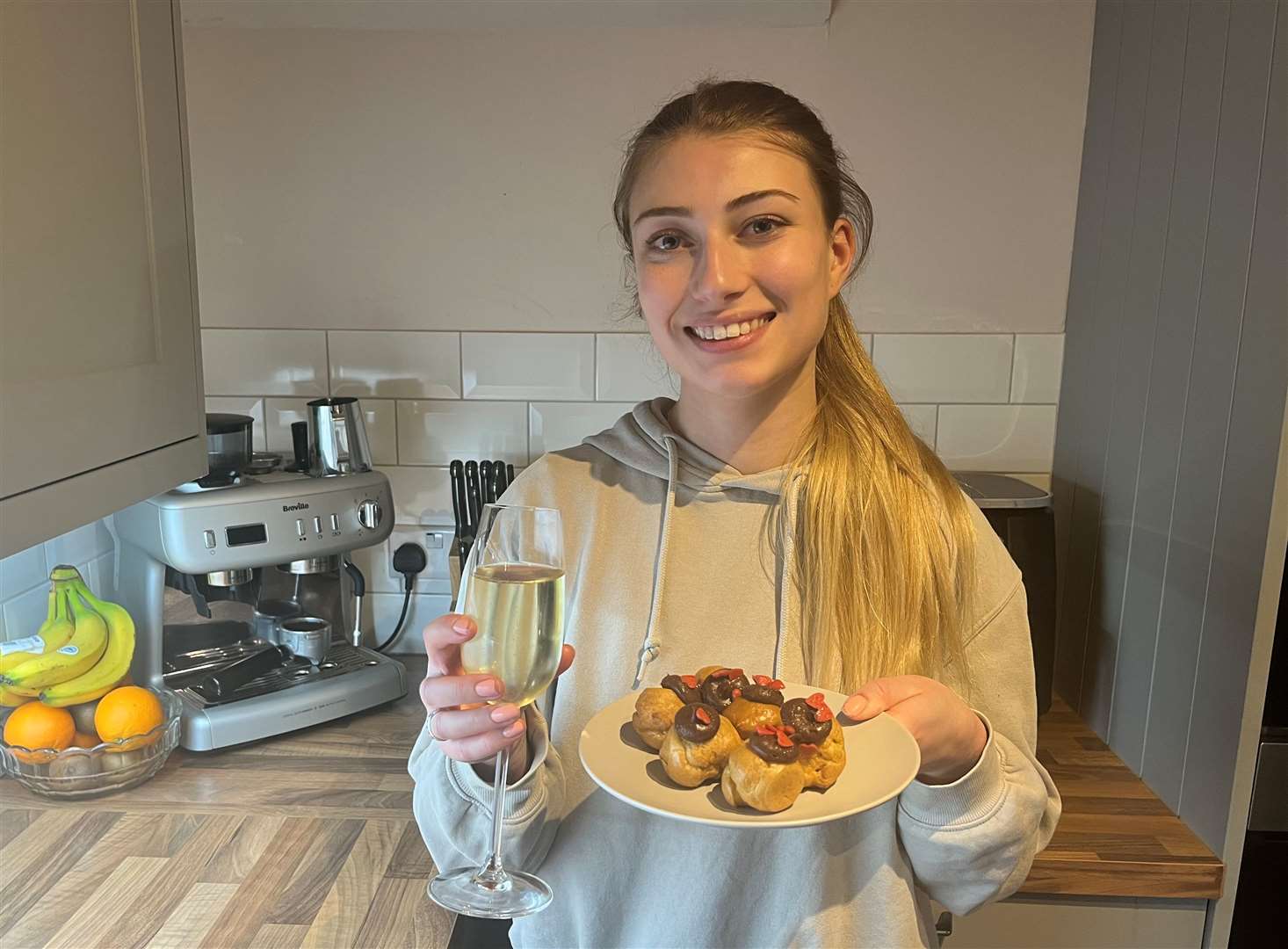 KentOnline reporter Chantal Weller with a glass of bubbles and the Asda dessert of profiteroles