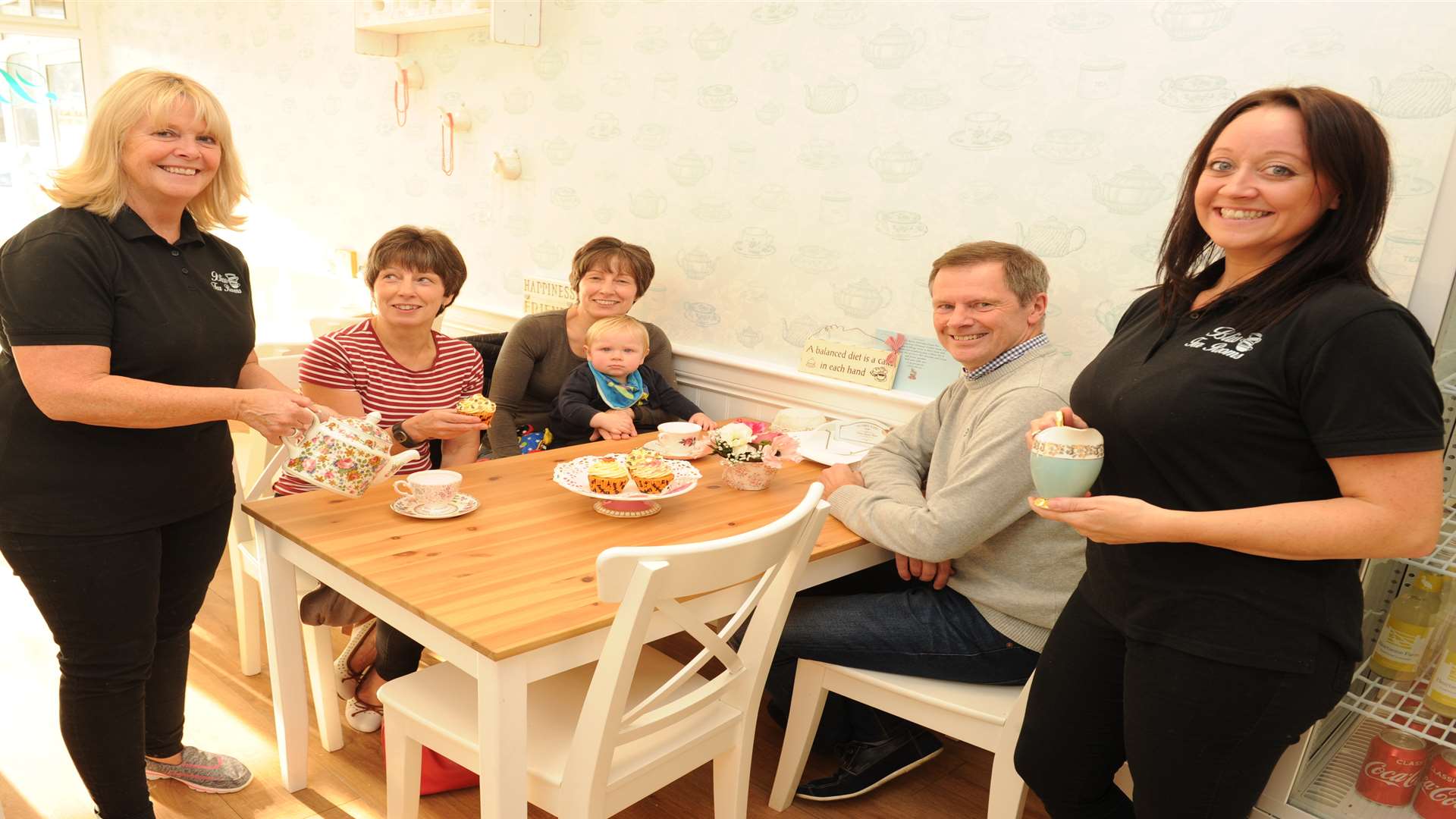 Cindie Shirley and Shirley Bliss with customers, twins Janet Laird and Anne Davies, baby Charlie Davies and Perry Davies