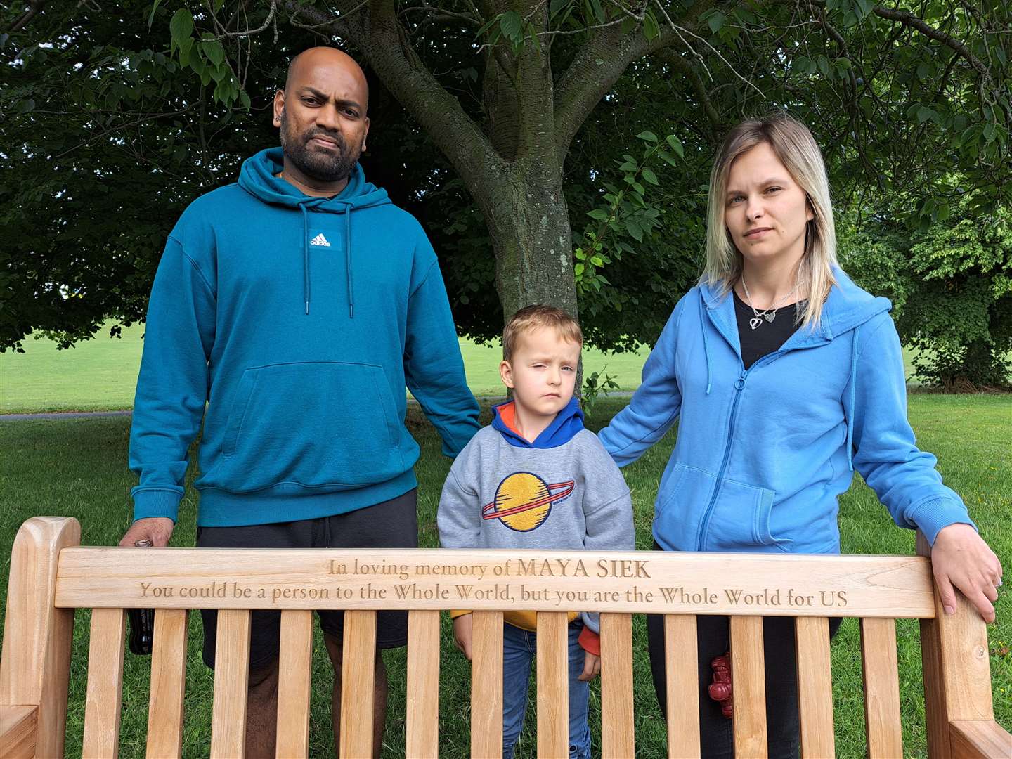 Raj Bande, Magdalena Wisniewska and their son Nathan with the bench dedicated to Maya