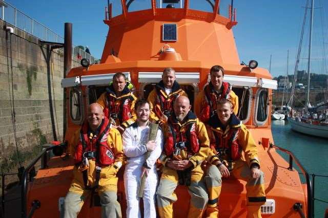 Jamie Clark with the Olympic torch on Dover lifeboat