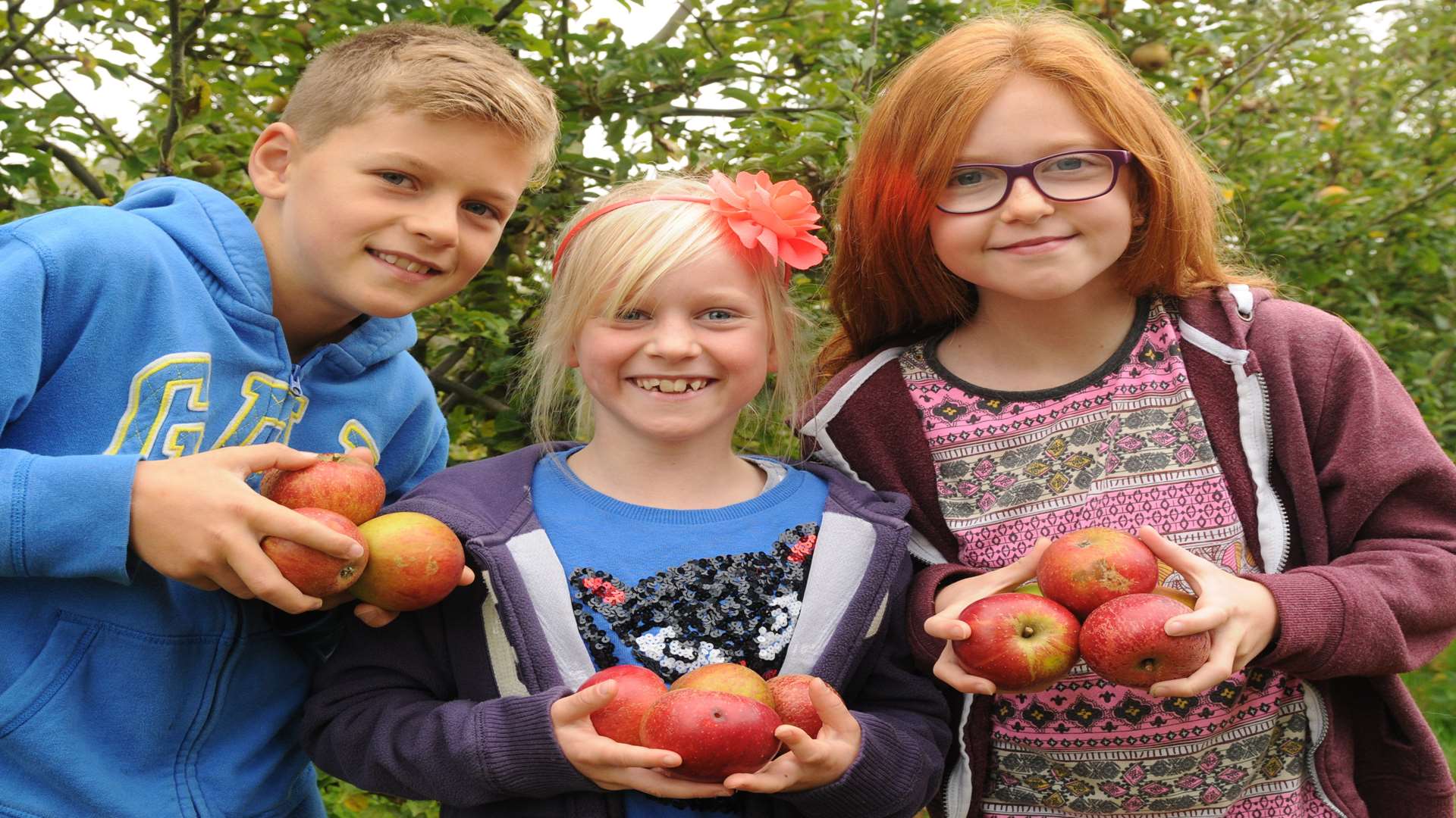 Jude and Lily Clarke (10,8) and Ruby Stoddard (9) at Rainham Community Orchard, Lower Bloors Lane, Rainham