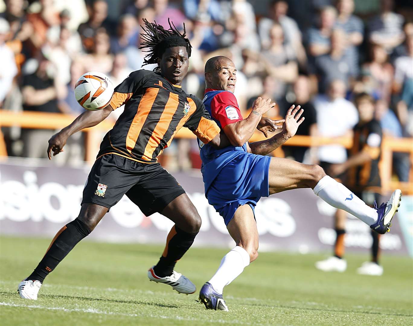 Clovis Kamdjo challenges Gills striker Deon Burton during his Barnet days Picture: Barry Goodwin