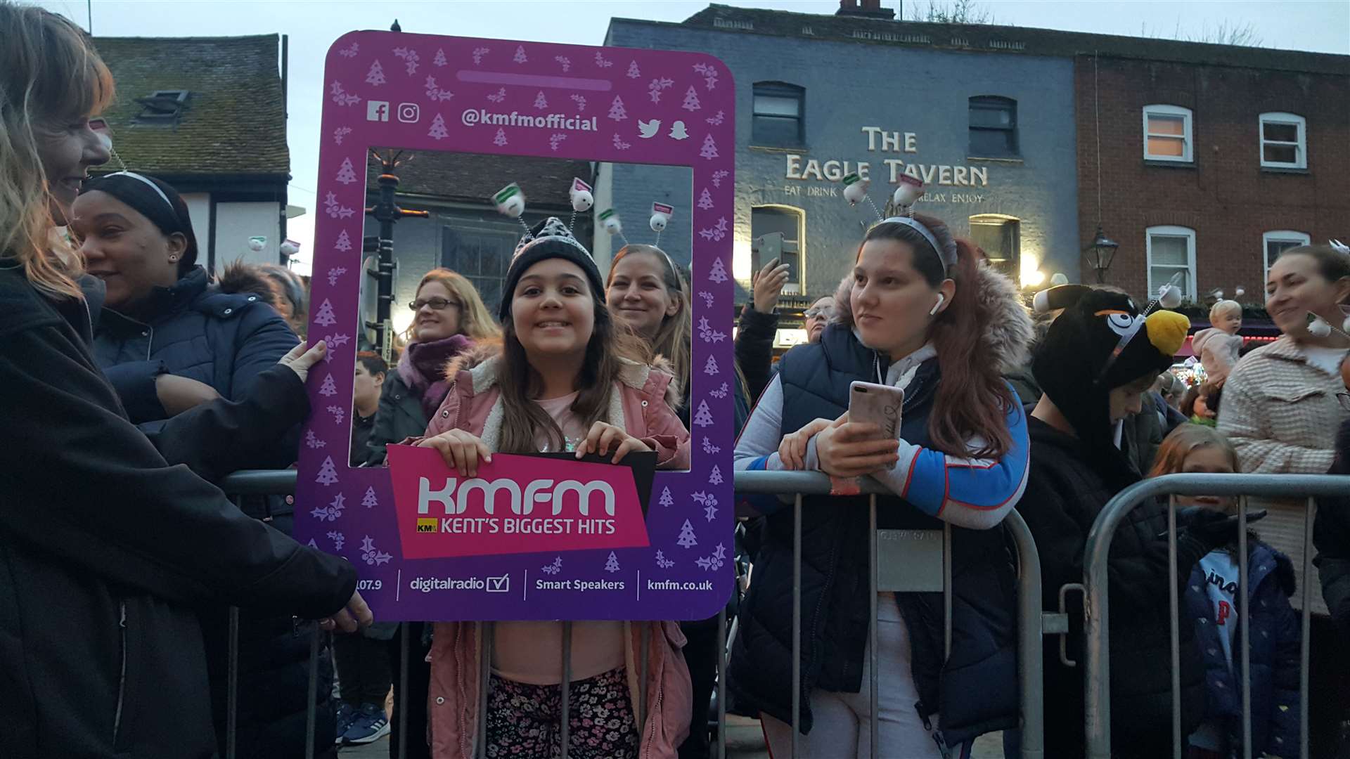 People posing with the KMFM selfie board