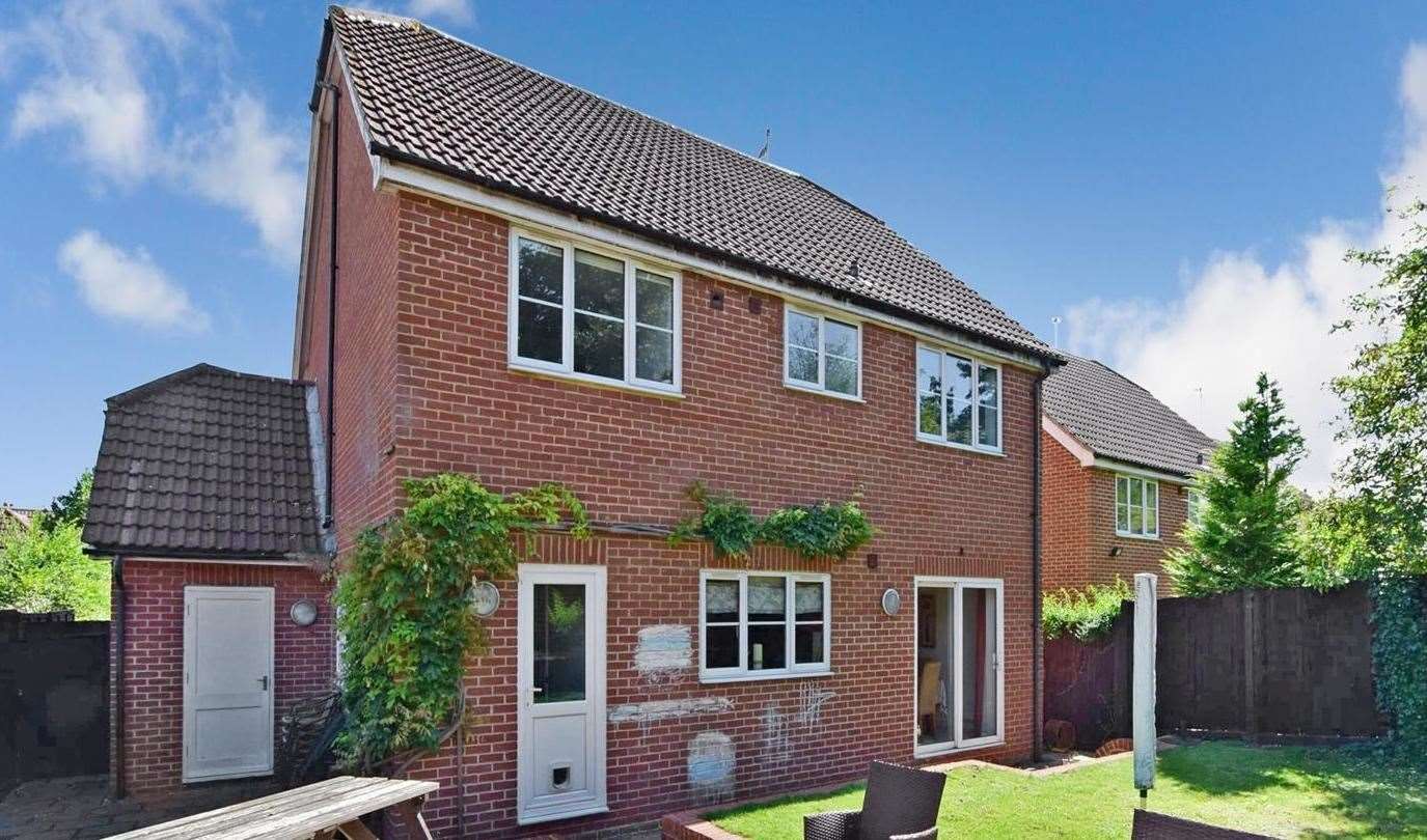 The back garden has a lawn and a patio