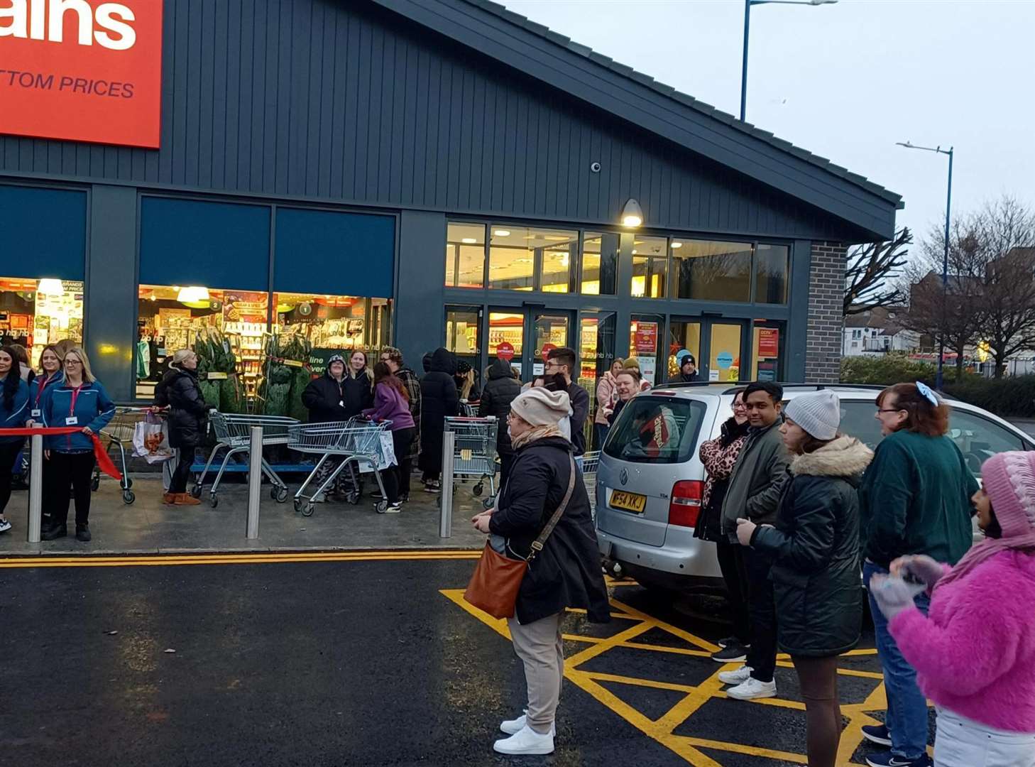 People eagerly awaiting the opening of discount store Home Bargains