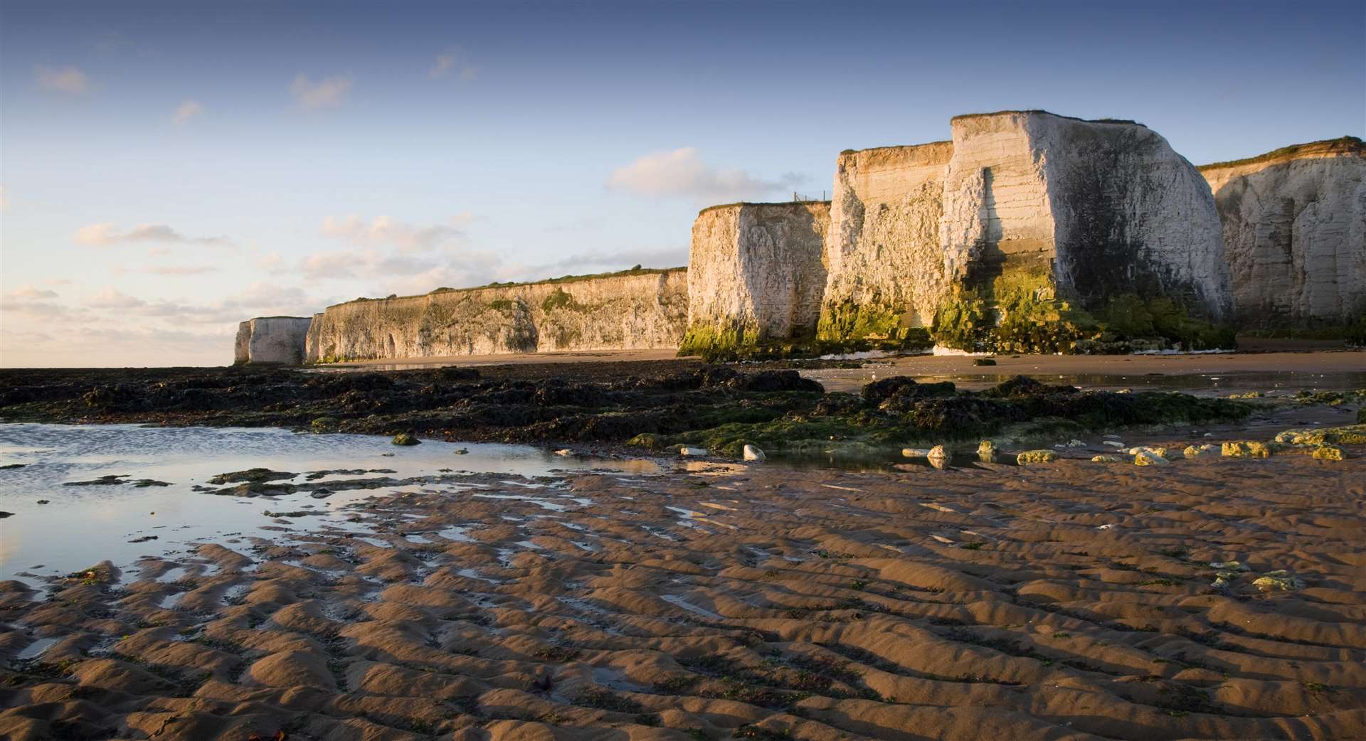 A view across the sandy foreshore at low tide