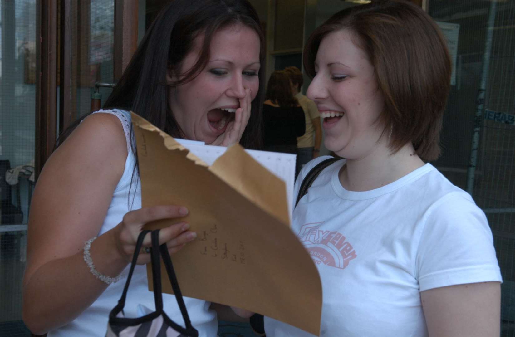 18-year-old’s Fiona Burgess (left) and Amy Roberts (right) cheerfully reading their A-level results at Highsted School in Sittingbourne. Picture: Mike Smith