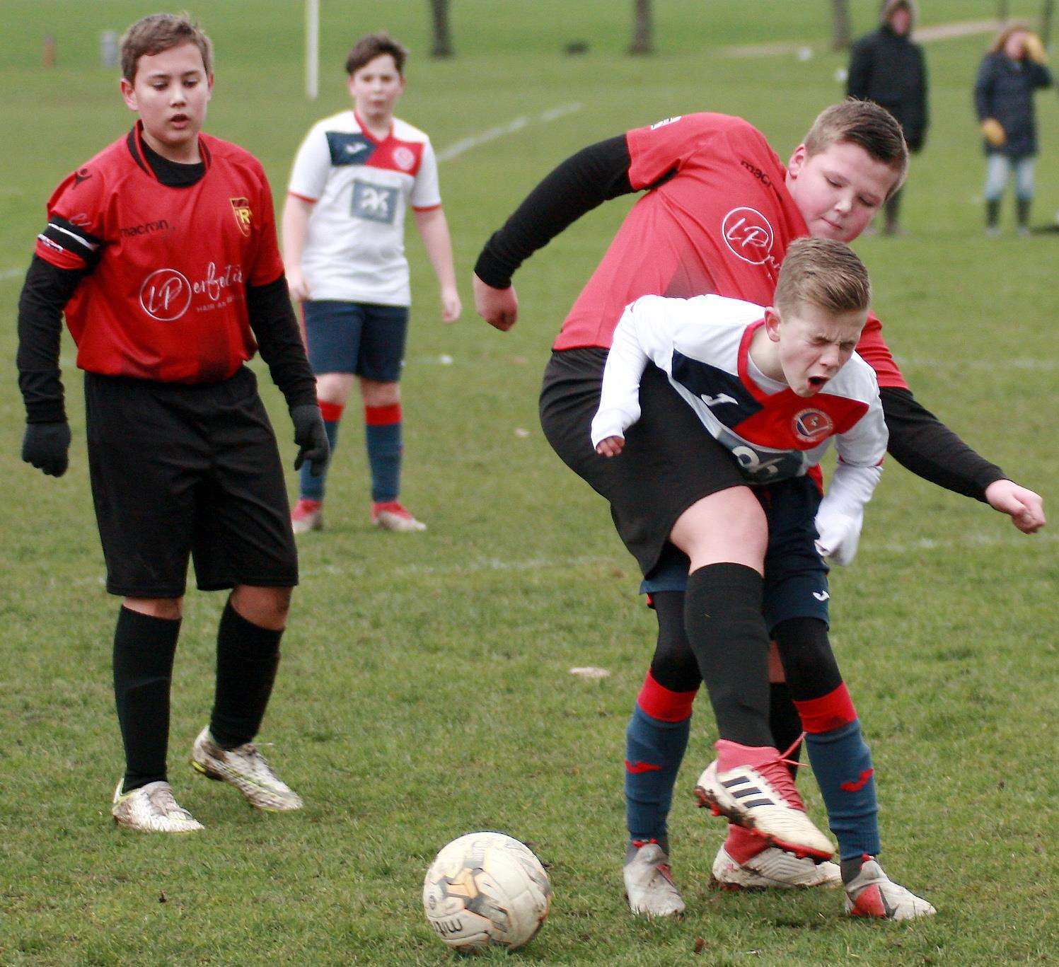 Hempstead Valley Rangers under-13s (white) feel the force of this Rainham 84 Devils under-13s challenge Picture: Phil Lee FM6792346