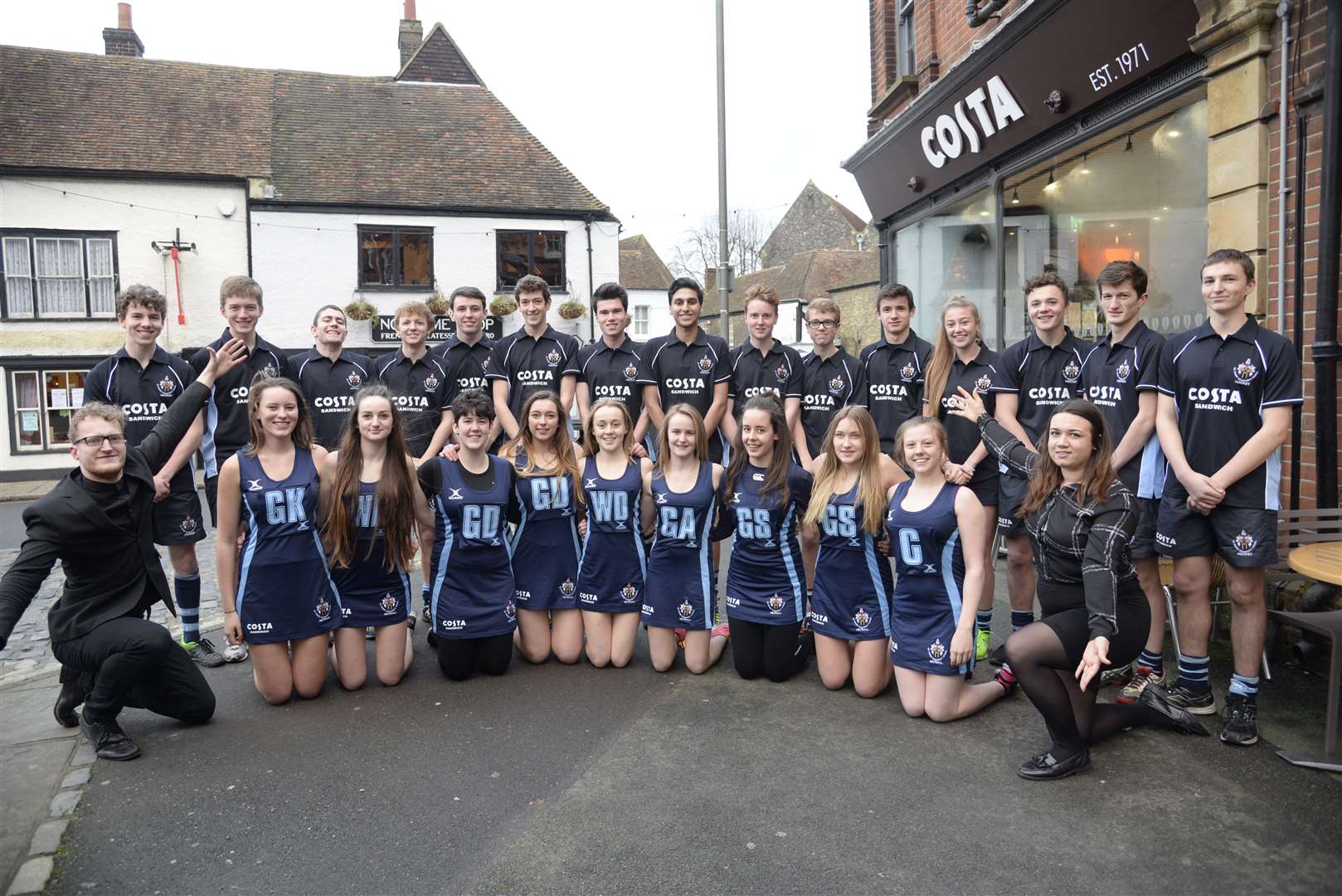 Alex Pomeroy, left and Sarah Bourne of Goldex with the Costa Coffee sponsored netball and Hockey teams from the Sir Roger Manwood's School