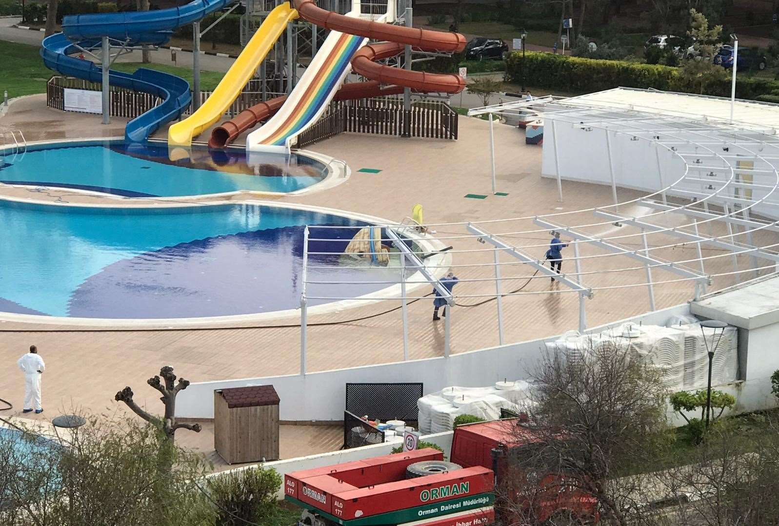 The abandoned pool, with a man in a white suit on the left