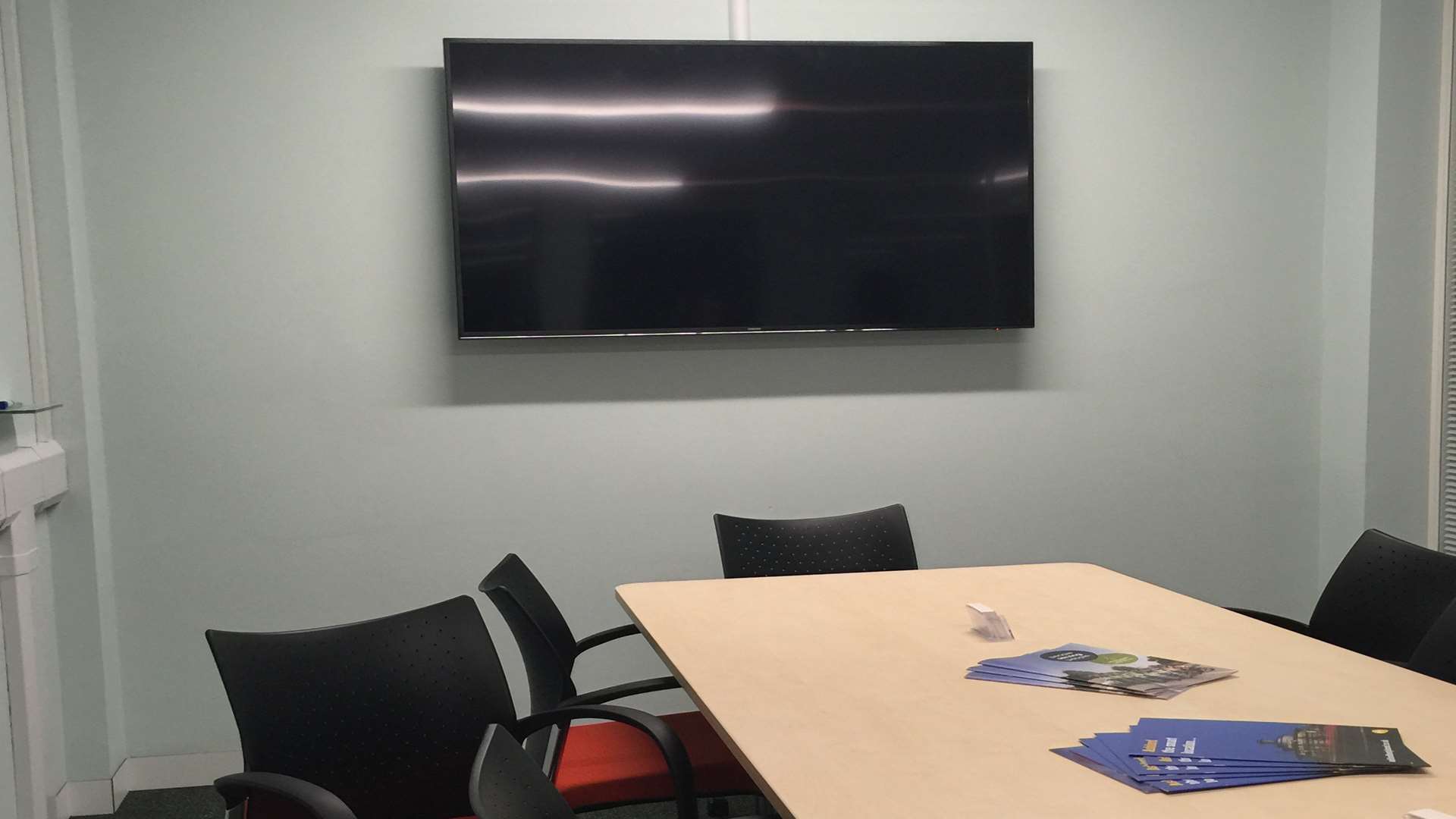 A 65 inch Samsung TV hangs on the wall of Gerry Clarkson's office