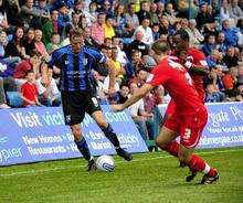 Mark Bentley tries to shrug off the attention of former Gills midfielder Albert Jarrett and Joe Anderson