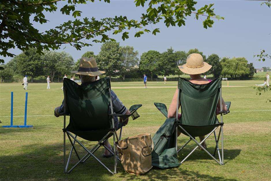 Watching cricket in sunshine. Library picture