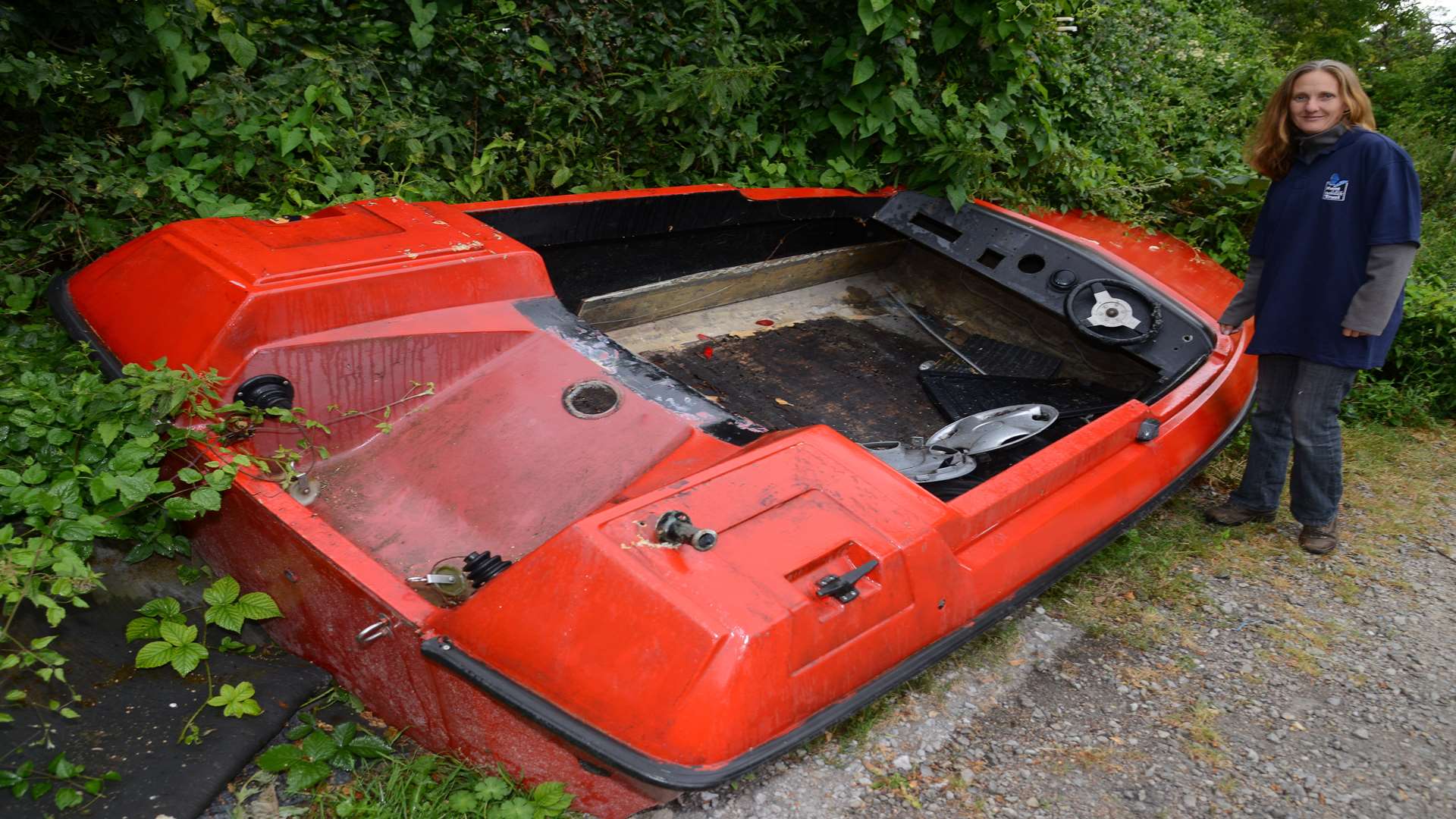 Reserve warden Alison Ruyter with the power boat dumped in the car park