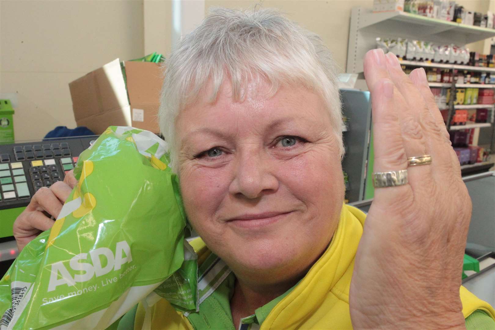 Checkout assistant June Cook is reunited with her old wedding ring that slipped off from her little finger while serving a customer at Asda on Pier Road in Gillingham. Picture: John Westhrop