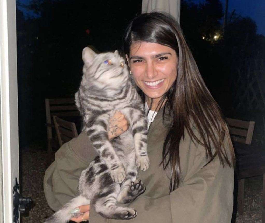 Sarah during one stay in Faversham, posing with a stray cat she befriended