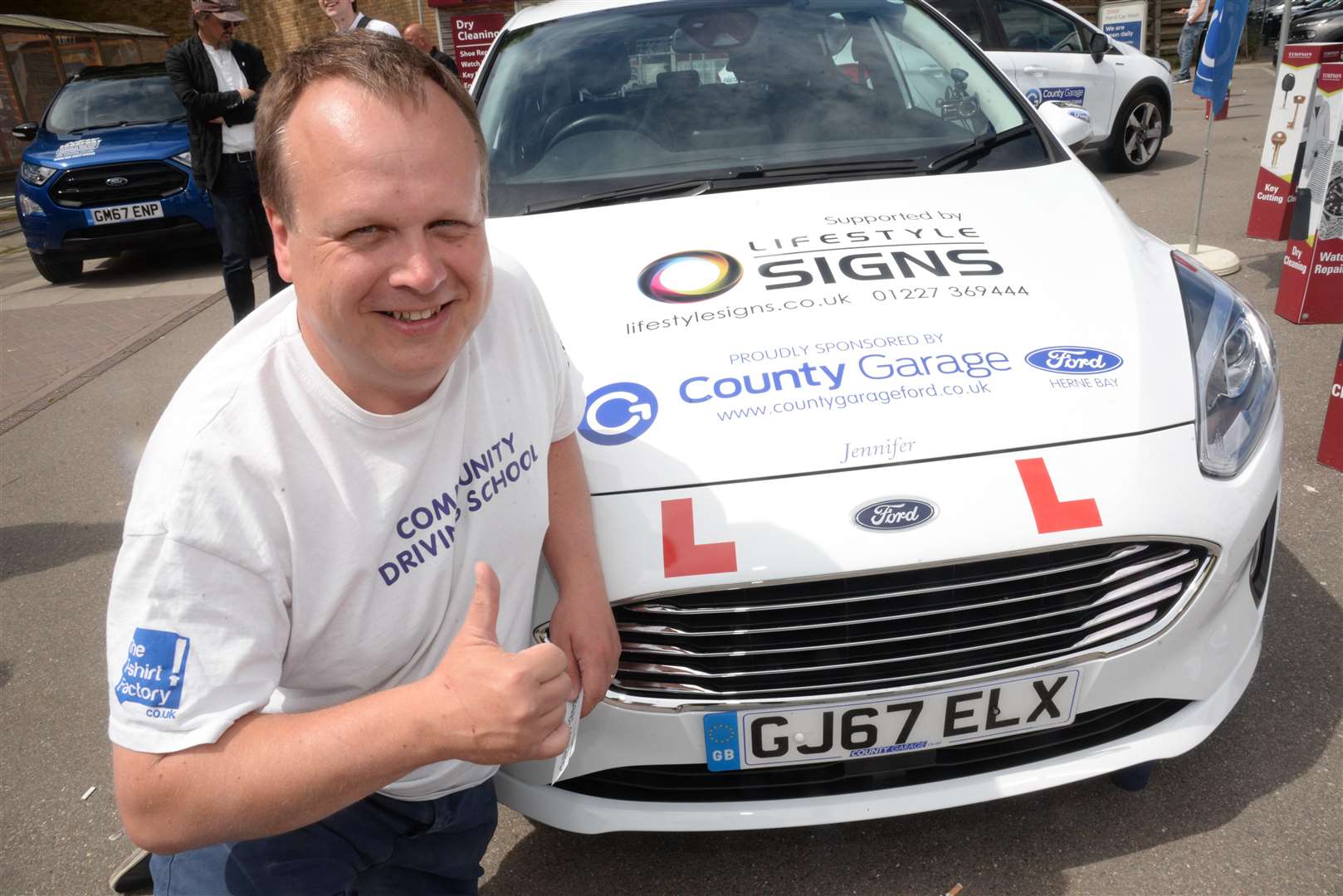 John Nicholson with his new car at Tesco's Millstrood Road store