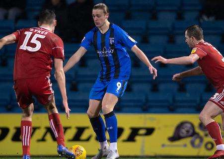 Tom Eaves sees his path to goal closed off by Ross Sykes and Mark Hughes Picture: Ady Kerry