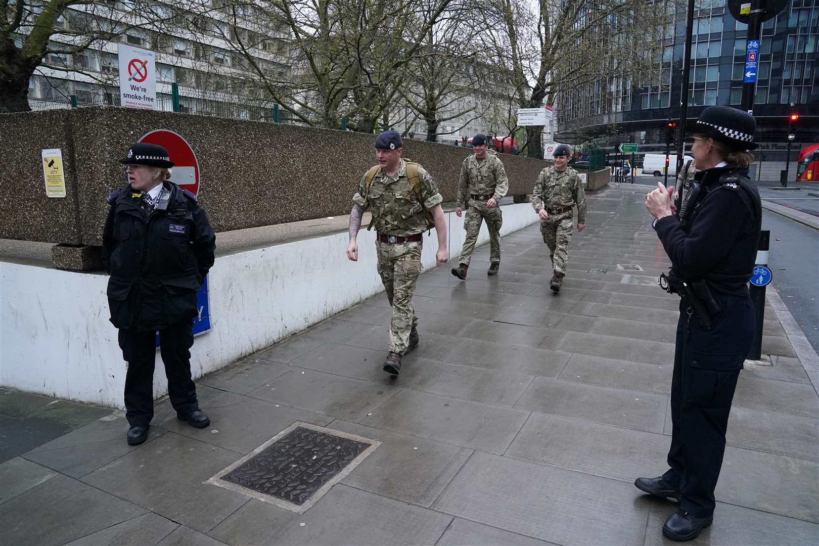 Military personnel and police officers outside St Thomas’ Hospital in central London where it is believed Prime Minister Boris Johnson was admitted (Aaron Chown/PA)