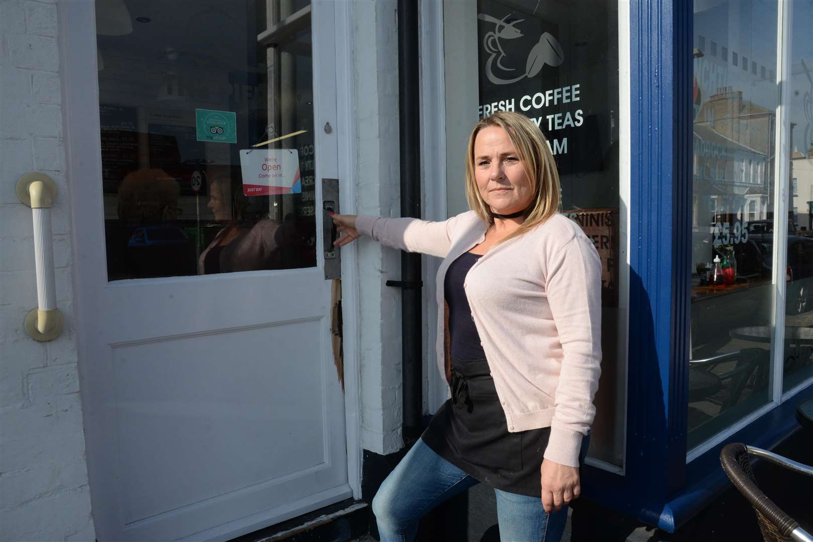 Paula Taylor by the damaged door at Frydays