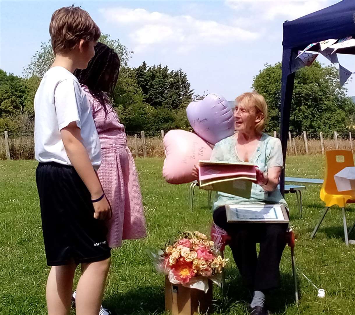 Polly Wilson received presents from pupils and a commemoration for 50 years of service at the school. Picture: Sharon Clark