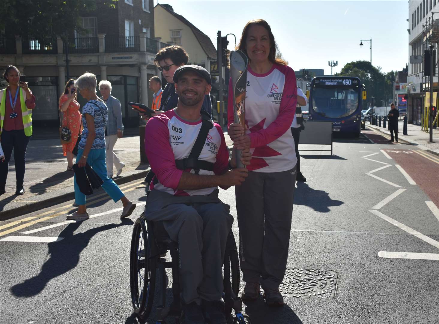 Swimming teacher Amanda Smih from Swanley, right, passes on the baton to Paralympian John Boy Smith Picture: Jason Arthur