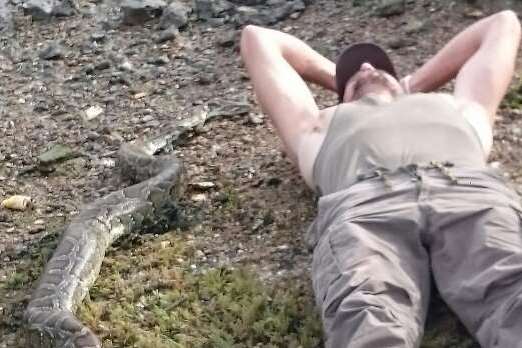 Maidstone landscaper Ross Turner, pictured, discovered this giant python on the beach on the Isle of Sheppey with his brother Mike Creighton while dog-walking