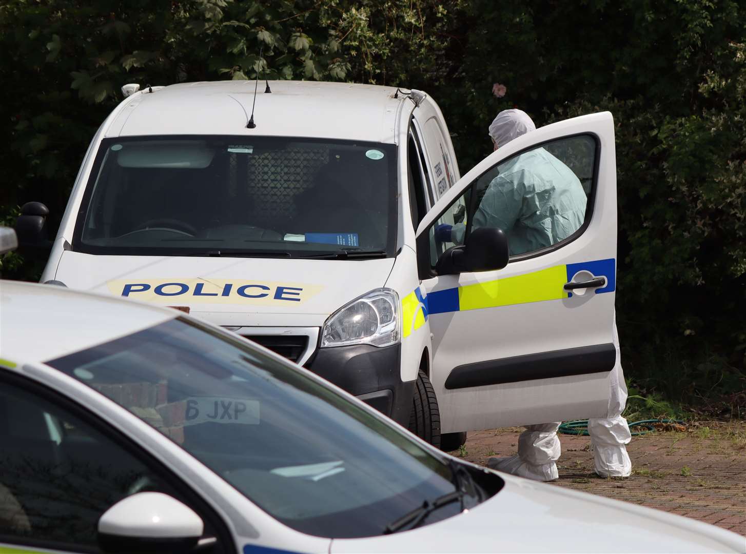 Police load evidence into a van