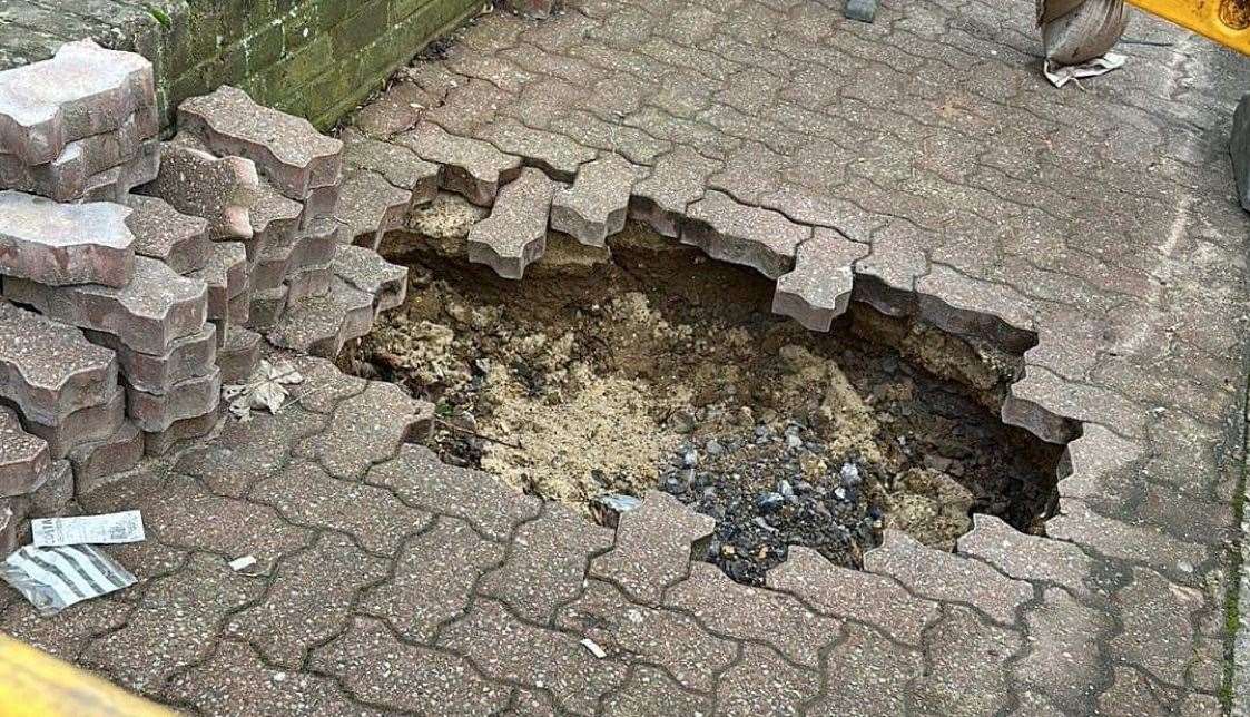 The hole outside the library/coffee shop in Tallents Close, Sutton-at-Hone