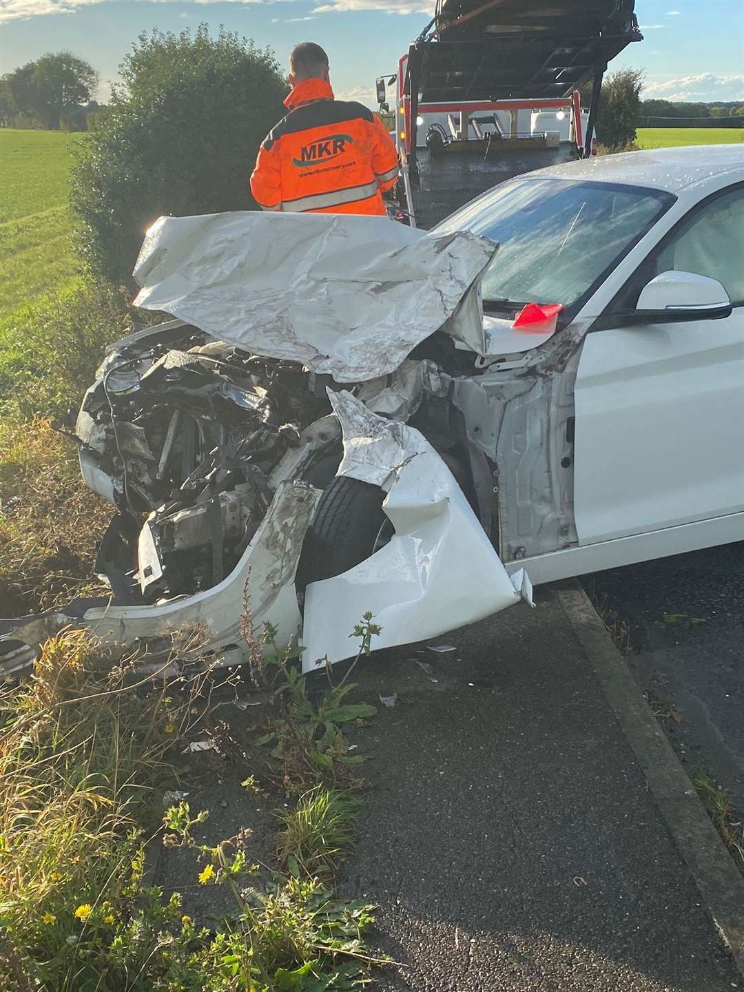 The crumpled front end of the BMW