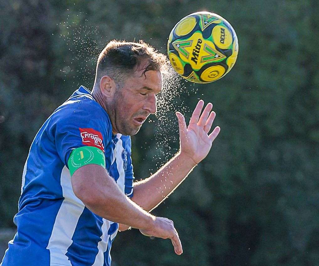 Herne Bay captain Liam Friend heads the ball. Picture: Helen Cooper