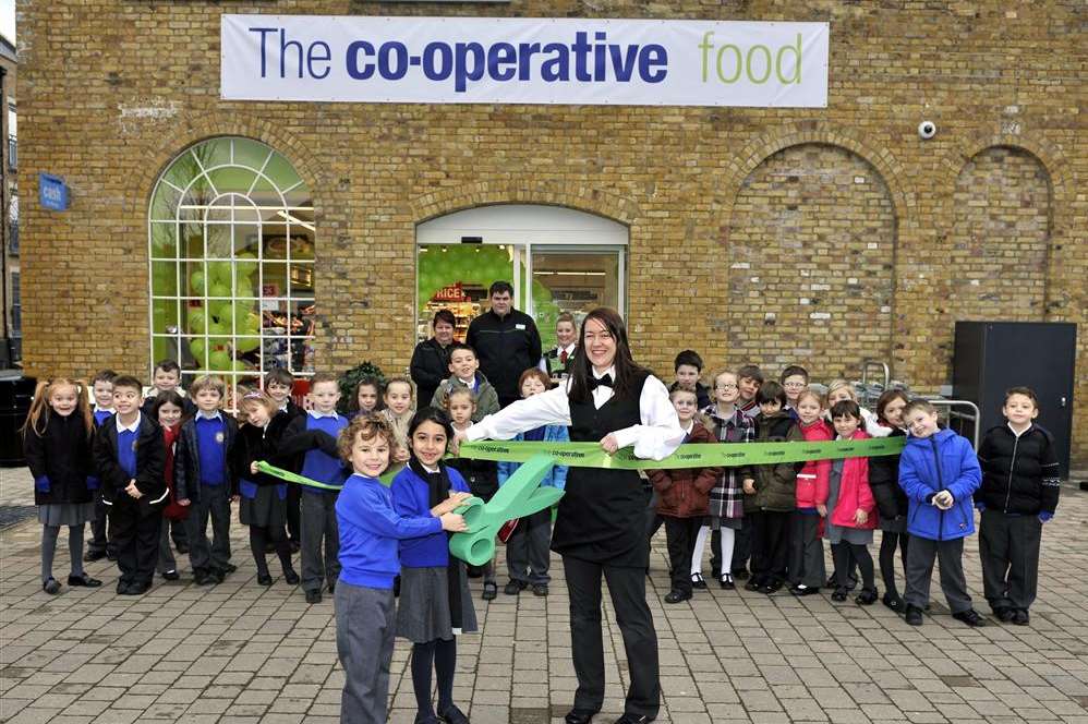 Store manager Rebecca Tormey opening the store with pupils from Horton Kirby Church of England Primary School