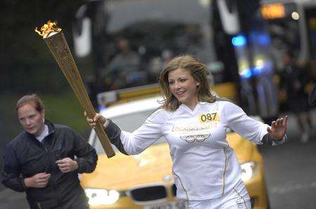 The Olympic torch being carried through Dover town centre