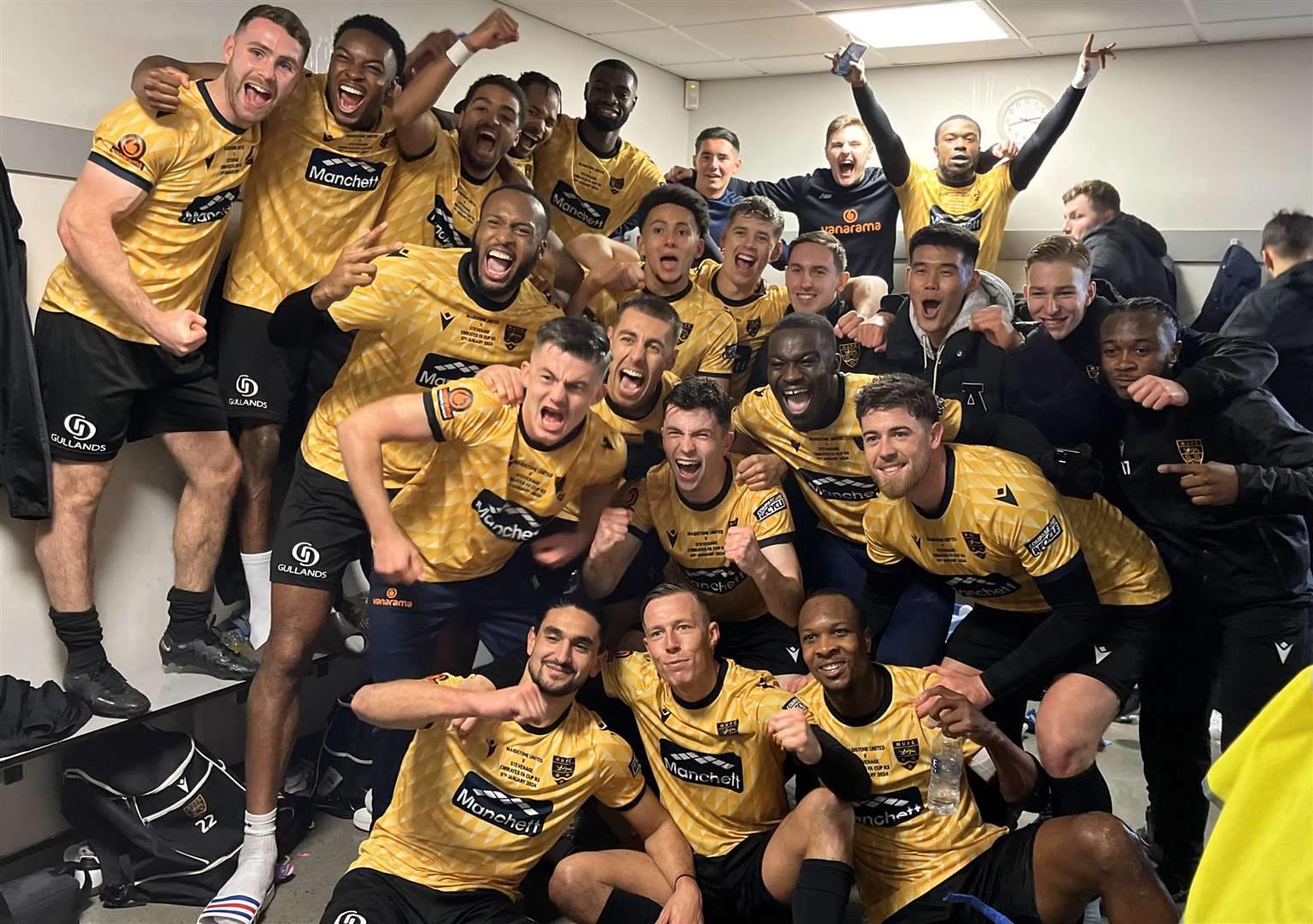 Maidstone United players celebrate in the dressing room after beating Stevenage. Picture: Steve Terrell