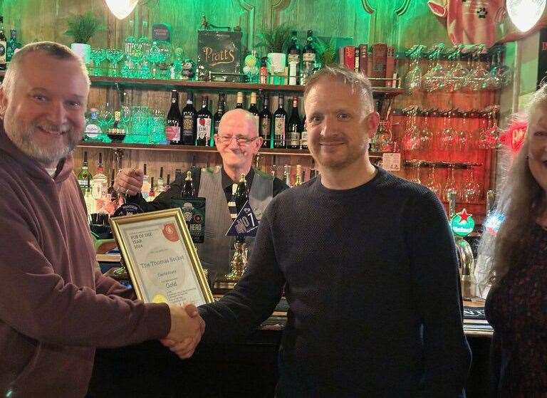 Manager of the Thomas Becket, Canterbury Chris Lurcock collecting his CAMRA Pub of the Year award. Picture: CAMRA