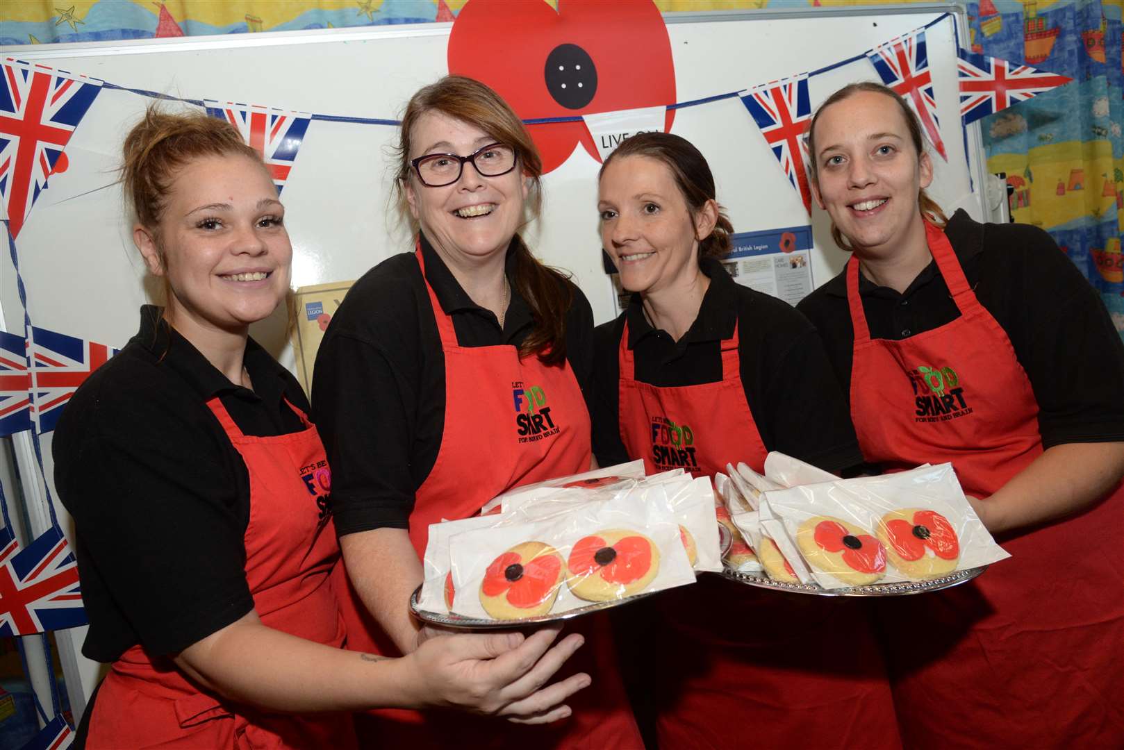 Catering staff Stacey Brachio, Shelley Davies-Edwards, Emma Bartholomew-Thomas and Loise Hickmott with the poppy decorated biscuits made by Shelley for the remembrance afternoon tea at Brookfield Infant School, Aylesford. Picture: Chris Davey