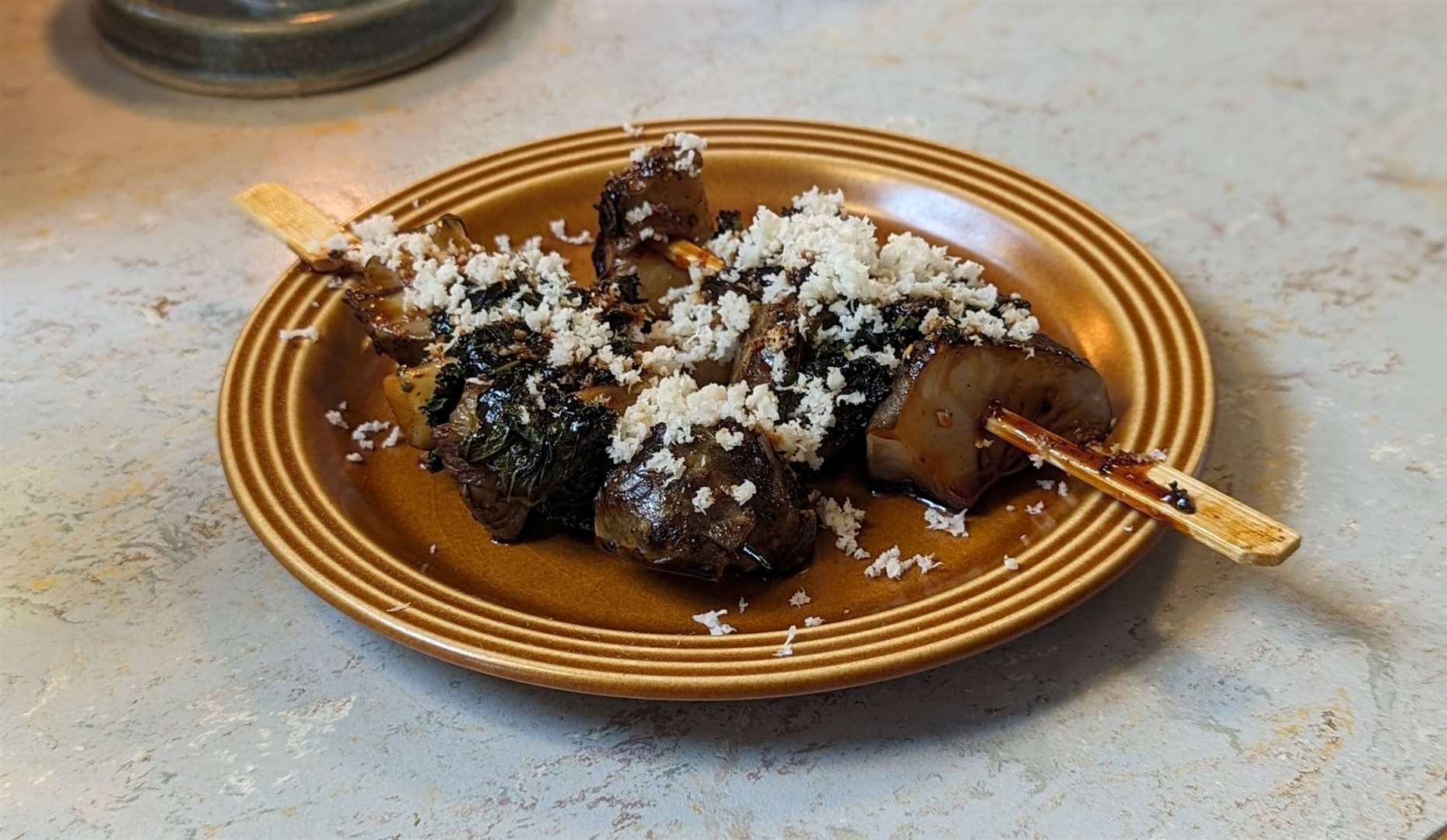 Skewers of Jerusalem artichoke and kale tops