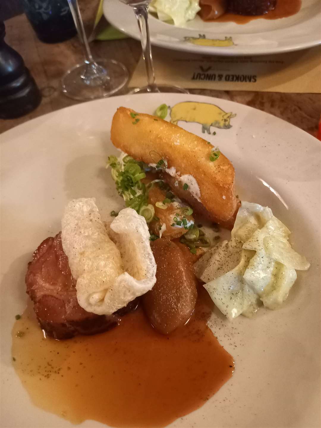 The main course of pork neck rib eye, cabbage and wedges