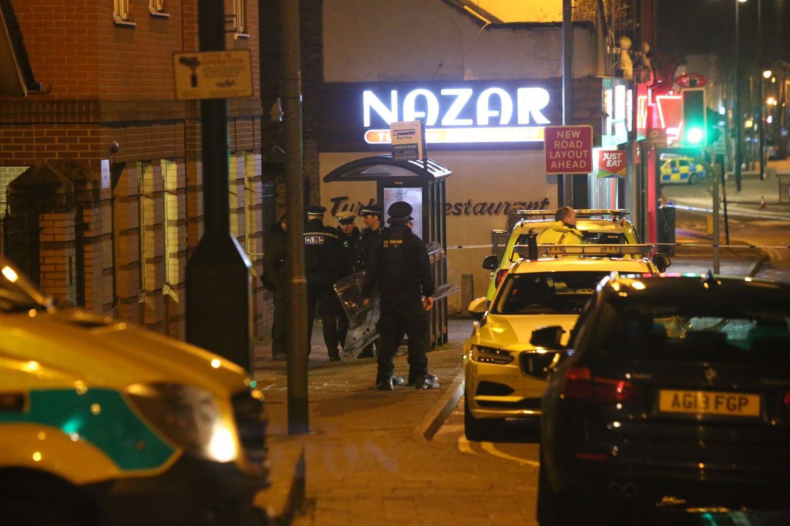 Police with riot shields in Chatham High Street after a man was spotted on the roof of a building. Picture: UK News and Pictures