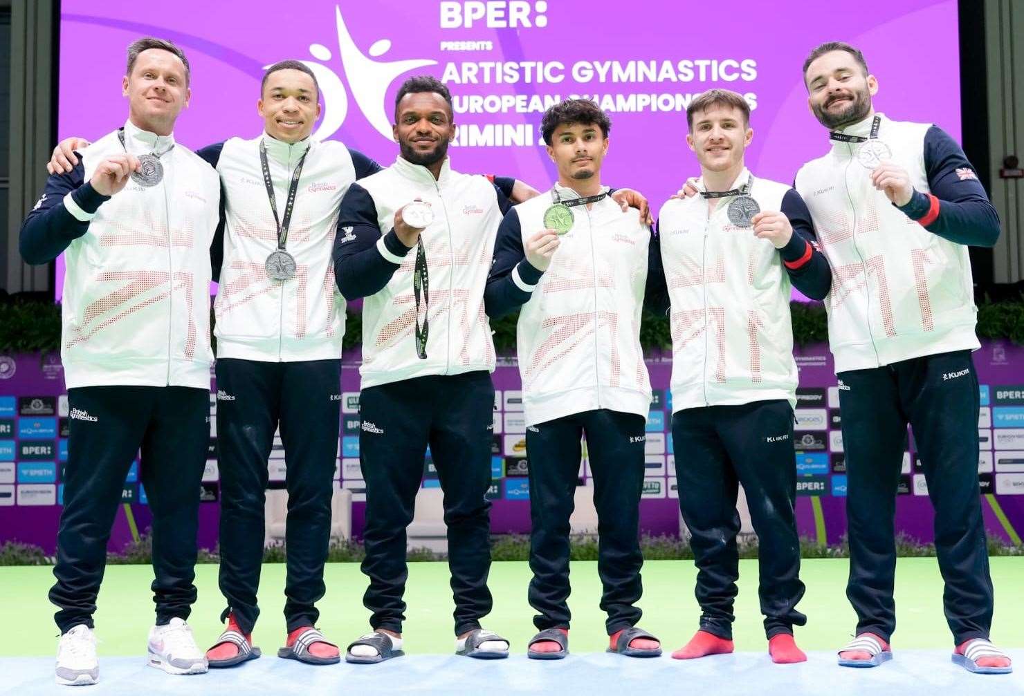 Maidstone's James Hall, far right, celebrates team silver at the European Artistic Gymnastics Championships. Picture: Simone Ferraro